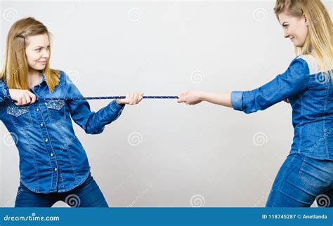 2 girls pulling a rope|Two Girls and A Woman Pulling A Rope Together ·。